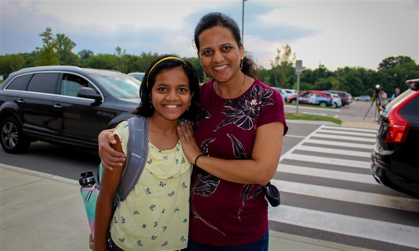 A mother and daughter smile